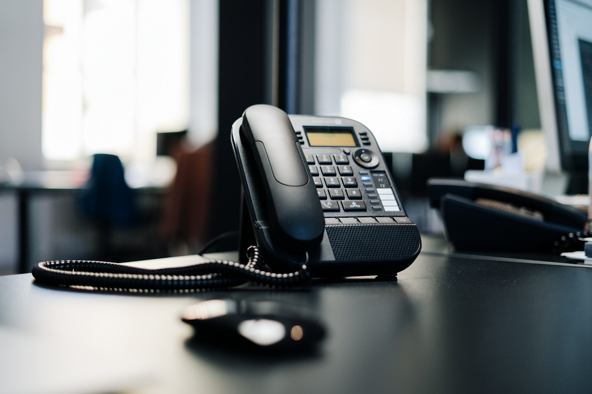 Unanswered desk phone in an empty office